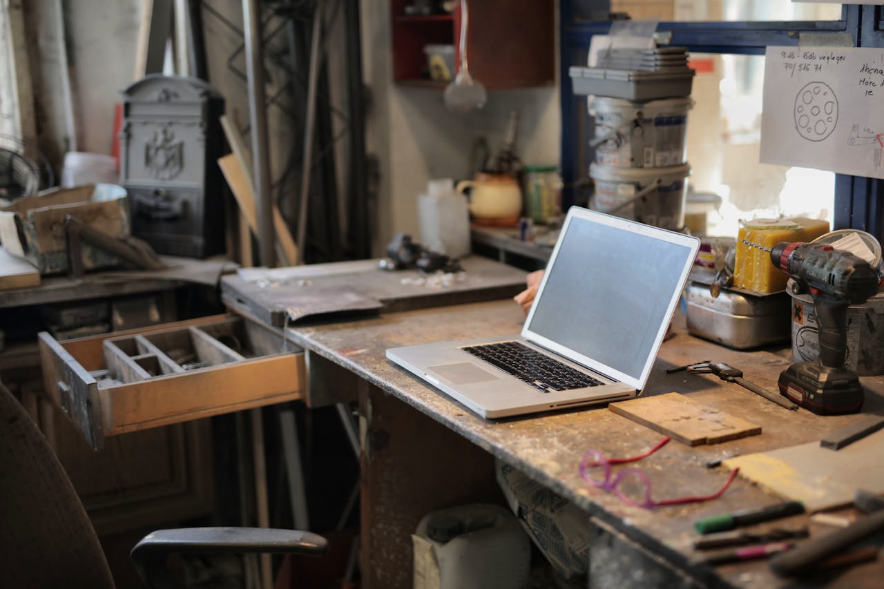 services-02 From above of modern laptop laying at table among different tools and equipment in workshop